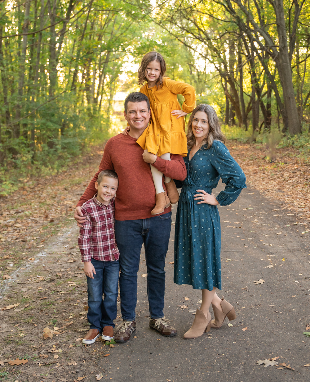 family pictures in fall location with color coordinated outfits
